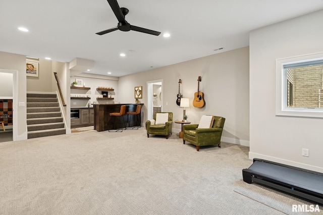 6925 Grover Sta, Bettendorf, IA 52722 - sitting room with a ceiling fan, stairs, wet bar, recessed lighting, and carpet