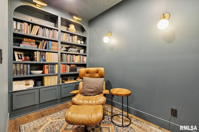 6925 Grover Sta, Bettendorf, IA 52722 - sitting room with wood finished floors and a textured ceiling