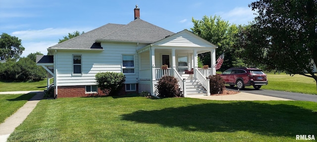 304 2nd St, Matherville, IL 61263 - bungalow featuring a porch, a front lawn, a shingled roof, and a chimney