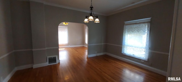 304 2nd St, Matherville, IL 61263 - spare room featuring arched walkways, ornamental molding, and wood finished floors