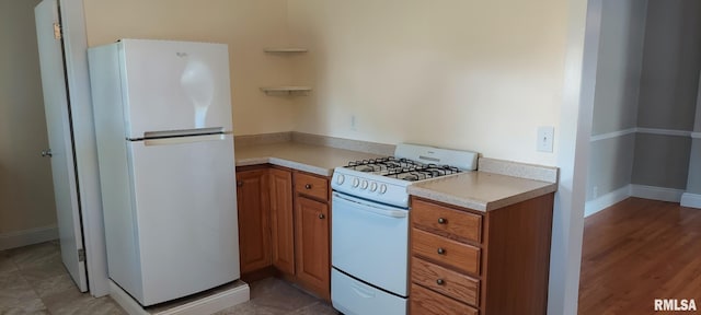 304 2nd St, Matherville, IL 61263 - kitchen with white appliances, brown cabinets, and light countertops