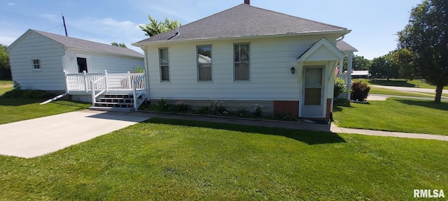 304 2nd St, Matherville, IL 61263 - view of front of house with a front yard, a shingled roof, and a wooden deck