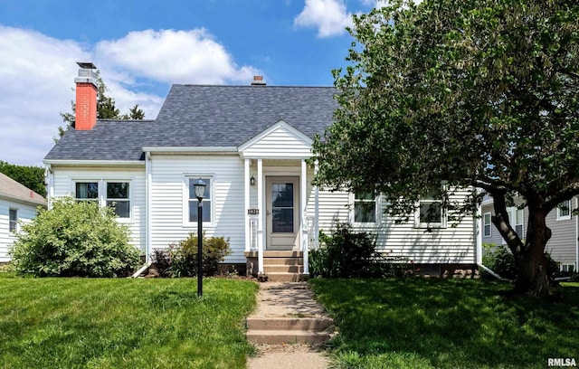 1020 Brown St, Bettendorf, IA 52722 - cape cod home featuring a front lawn, a chimney, and a shingled roof