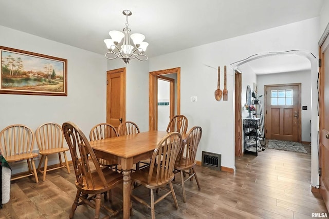 1020 Brown St, Bettendorf, IA 52722 - dining room featuring a chandelier and light wood-style flooring