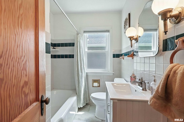 1020 Brown St, Bettendorf, IA 52722 - full bath with tile patterned floors, tile walls, shower / bath combo with shower curtain, vanity, and wainscoting