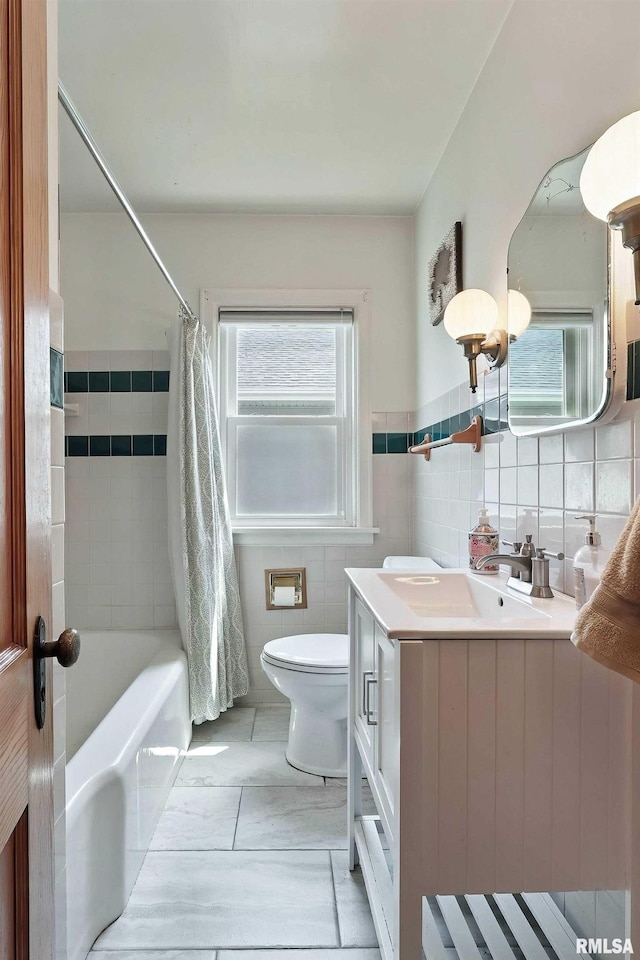 1020 Brown St, Bettendorf, IA 52722 - bathroom featuring vanity, tile walls, shower / bath combo, and wainscoting