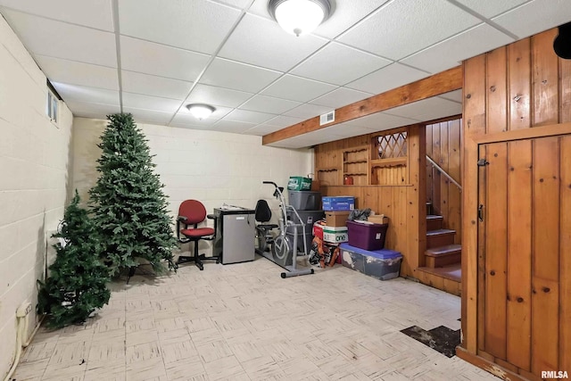 1020 Brown St, Bettendorf, IA 52722 - finished basement with stairway, concrete block wall, wooden walls, and a paneled ceiling