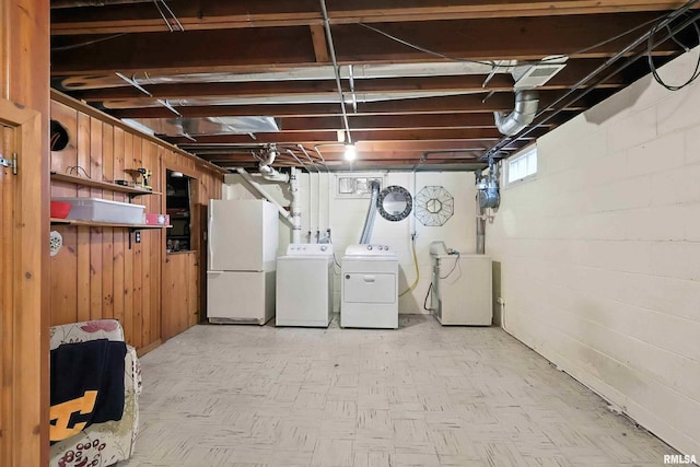 1020 Brown St, Bettendorf, IA 52722 - basement with freestanding refrigerator, separate washer and dryer, and wood walls