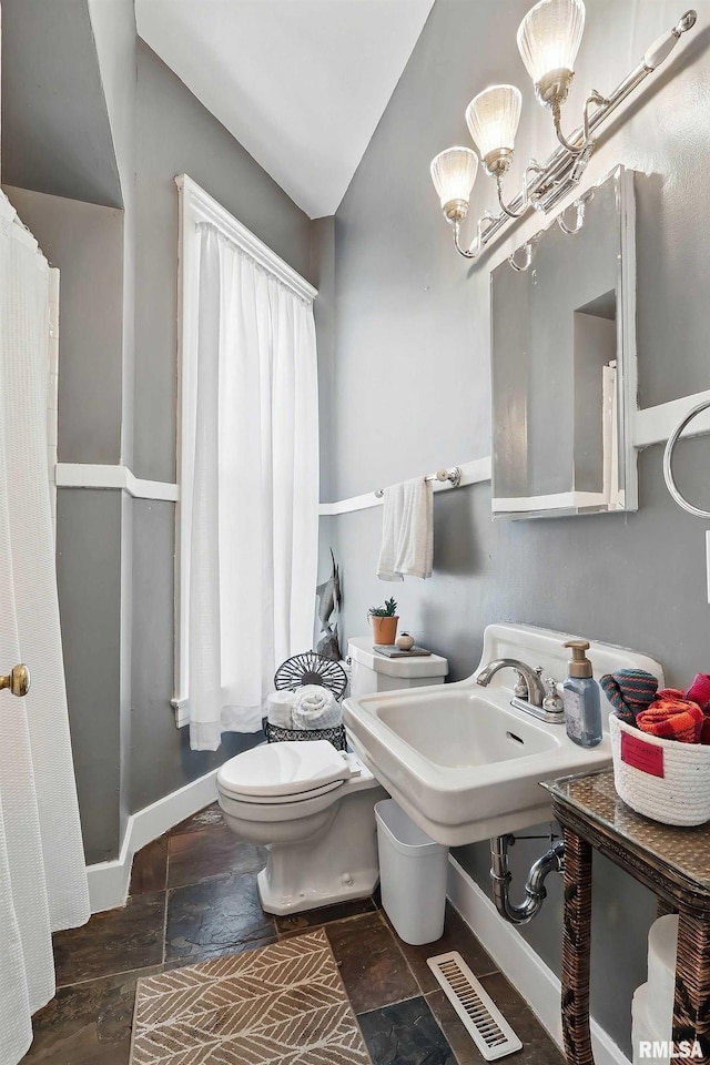 1703 20th St, Rock Island, IL 61201 - bathroom with a shower with curtain, stone finish flooring, a chandelier, and vaulted ceiling