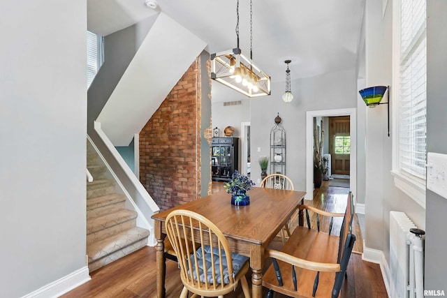1703 20th St, Rock Island, IL 61201 - dining space featuring radiator, wood finished floors, and stairway