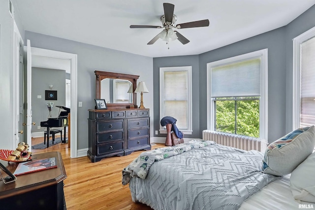 1703 20th St, Rock Island, IL 61201 - bedroom featuring light wood finished floors, radiator, and ceiling fan