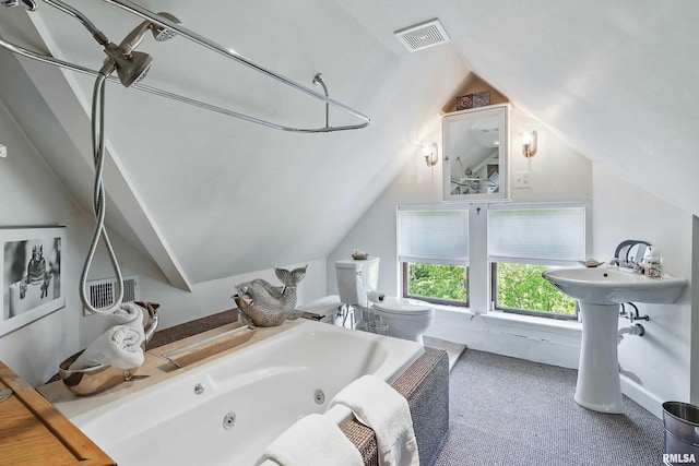 1703 20th St, Rock Island, IL 61201 - bathroom featuring vaulted ceiling and a tub with jets