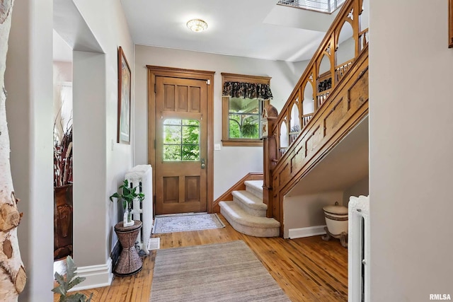 1703 20th St, Rock Island, IL 61201 - foyer with stairway, light wood-style floors, and radiator