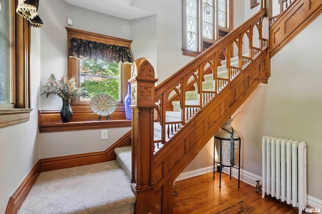 1703 20th St, Rock Island, IL 61201 - stairway featuring radiator and wood finished floors