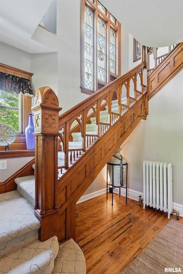 1703 20th St, Rock Island, IL 61201 - stairs with radiator, hardwood / wood-style flooring, and a high ceiling