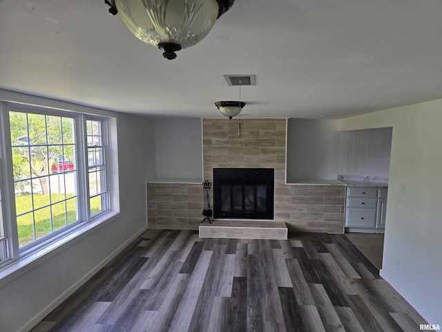2505 Cody St, Bettendorf, IA 52722 - unfurnished living room with a tile fireplace and wood finished floors