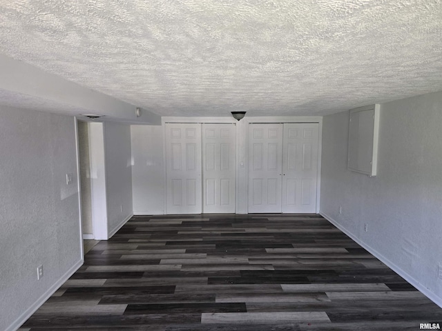 2505 Cody St, Bettendorf, IA 52722 - unfurnished room with a textured ceiling, dark wood-type flooring, and a textured wall