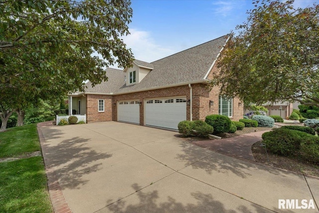 5985 Eagle Ridge Rd, Bettendorf, IA 52722 - view of front of house featuring brick siding, an attached garage, concrete driveway, and a shingled roof