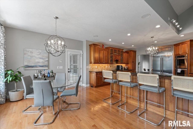 5985 Eagle Ridge Rd, Bettendorf, IA 52722 - dining space with a chandelier, light wood-style floors, and recessed lighting