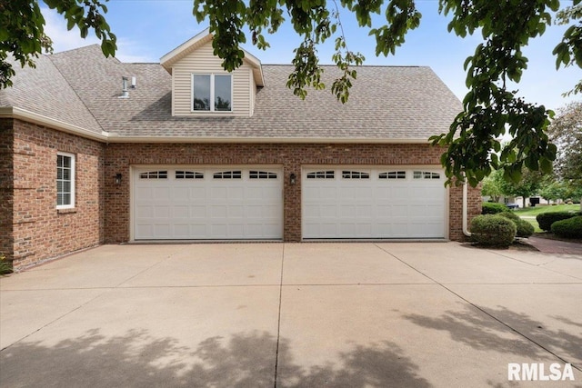 5985 Eagle Ridge Rd, Bettendorf, IA 52722 - view of front of house with driveway, brick siding, roof with shingles, and an attached garage