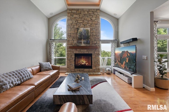 5985 Eagle Ridge Rd, Bettendorf, IA 52722 - living area featuring lofted ceiling, a fireplace, and wood finished floors