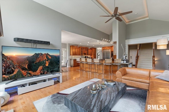 5985 Eagle Ridge Rd, Bettendorf, IA 52722 - living area with ceiling fan, high vaulted ceiling, light wood finished floors, and stairway