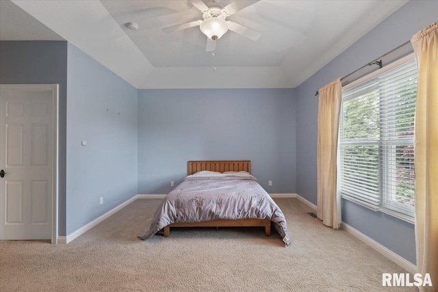 5985 Eagle Ridge Rd, Bettendorf, IA 52722 - bedroom with carpet floors, a tray ceiling, and ceiling fan