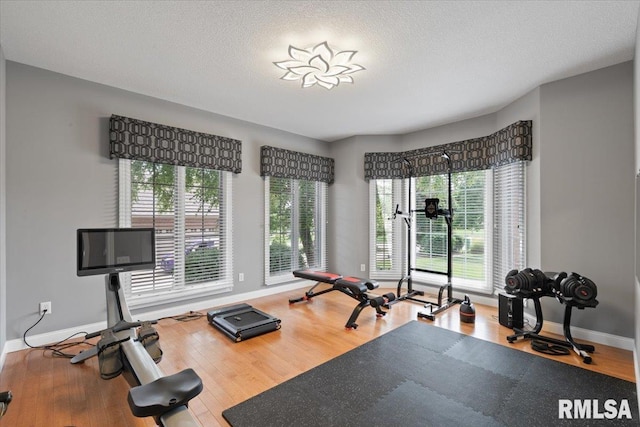 5985 Eagle Ridge Rd, Bettendorf, IA 52722 - exercise room featuring wood finished floors and a textured ceiling