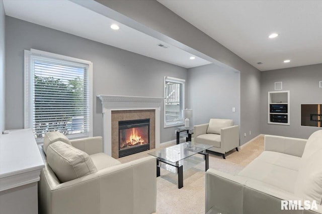 5985 Eagle Ridge Rd, Bettendorf, IA 52722 - living area with light carpet, a tiled fireplace, recessed lighting, and healthy amount of natural light