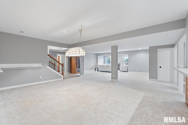 5985 Eagle Ridge Rd, Bettendorf, IA 52722 - unfurnished living room featuring carpet floors and stairway