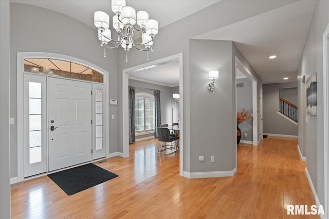 5985 Eagle Ridge Rd, Bettendorf, IA 52722 - entryway featuring a chandelier, light wood finished floors, and stairs