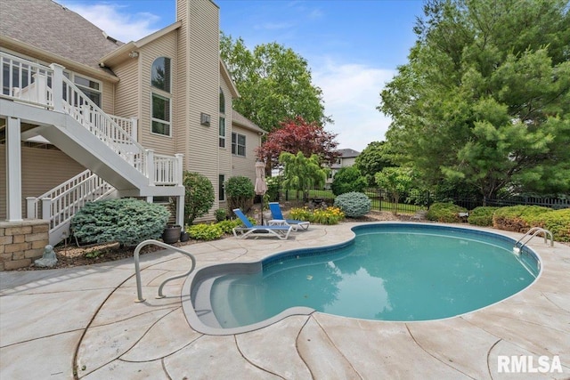 5985 Eagle Ridge Rd, Bettendorf, IA 52722 - view of pool with stairway, a patio, and a wooden deck