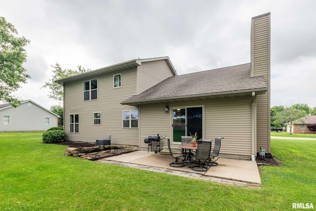 1514 E Willow Dr, Marion, IL 62959 - rear view of property featuring a patio, a lawn, and a chimney