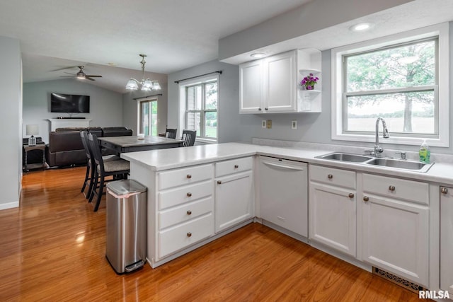 1514 E Willow Dr, Marion, IL 62959 - kitchen with dishwasher, a peninsula, light countertops, light wood-type flooring, and white cabinetry