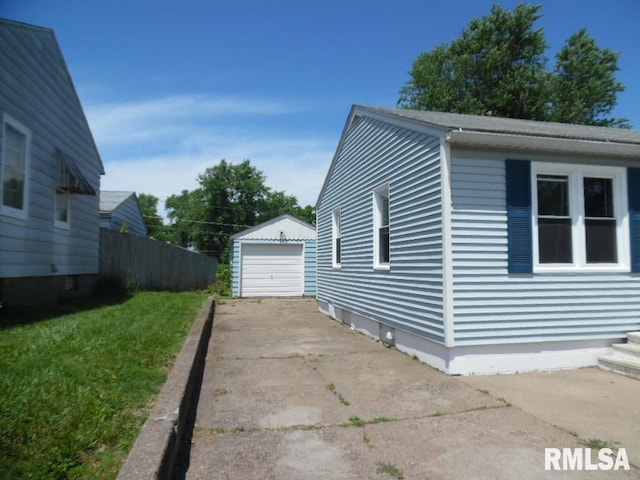 1444 Prospect Ave, Clinton, IA 52732 - view of side of home featuring a garage, an outbuilding, and driveway