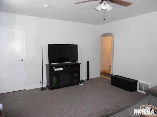 1444 Prospect Ave, Clinton, IA 52732 - carpeted living area featuring arched walkways and a ceiling fan