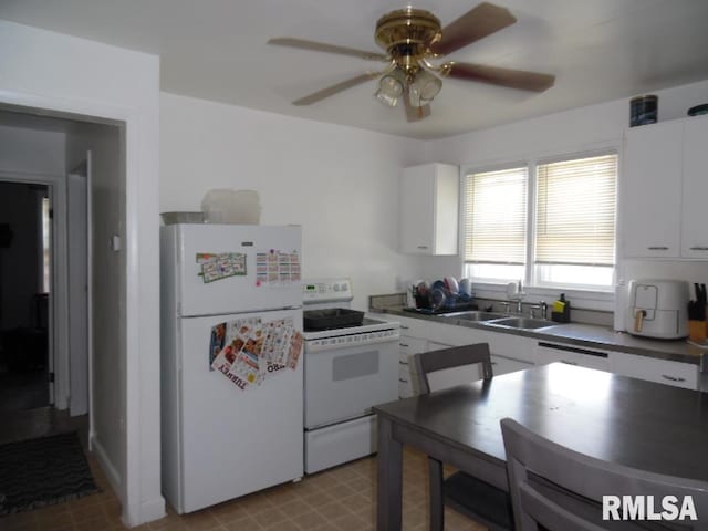 1444 Prospect Ave, Clinton, IA 52732 - kitchen with white appliances, white cabinets, a ceiling fan, and dark countertops