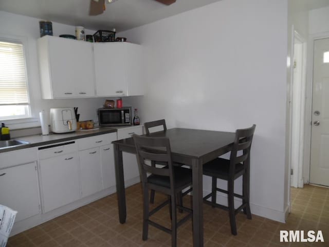 1444 Prospect Ave, Clinton, IA 52732 - dining space featuring tile patterned floors and a ceiling fan