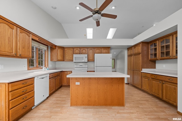 10 Briarwood Ln Unit 10, Rock Island, IL 61201 - kitchen featuring white appliances, lofted ceiling, ceiling fan, a center island, and light wood-style floors