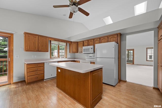 10 Briarwood Ln Unit 10, Rock Island, IL 61201 - kitchen featuring white appliances, light countertops, a kitchen island, vaulted ceiling, and light wood-style floors