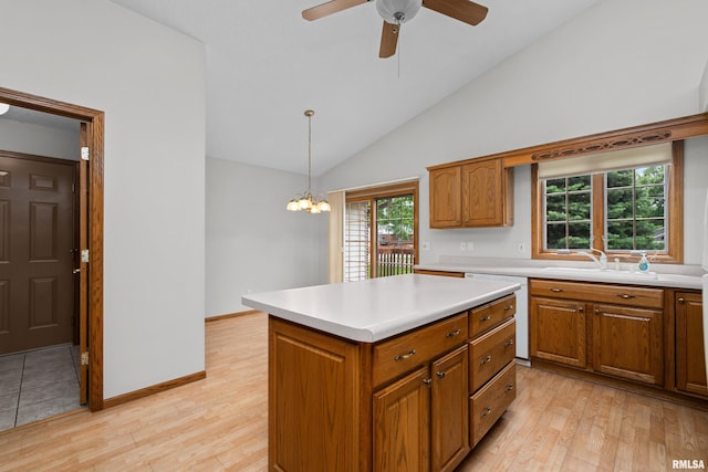 10 Briarwood Ln Unit 10, Rock Island, IL 61201 - kitchen featuring dishwasher, brown cabinetry, light countertops, lofted ceiling, and light wood-style floors