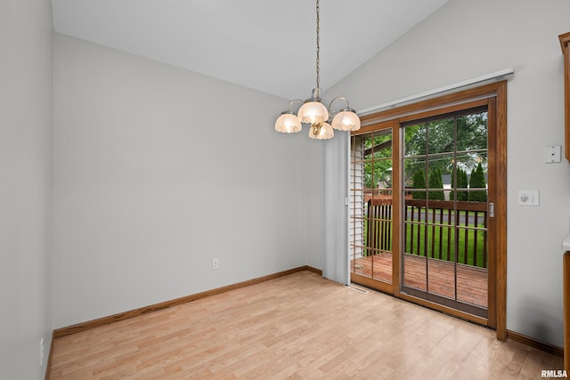 10 Briarwood Ln Unit 10, Rock Island, IL 61201 - unfurnished room featuring light wood-type flooring, a chandelier, and lofted ceiling