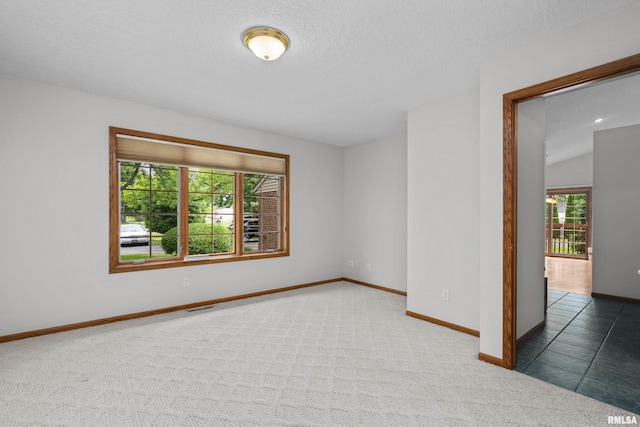 10 Briarwood Ln Unit 10, Rock Island, IL 61201 - spare room featuring baseboards and carpet