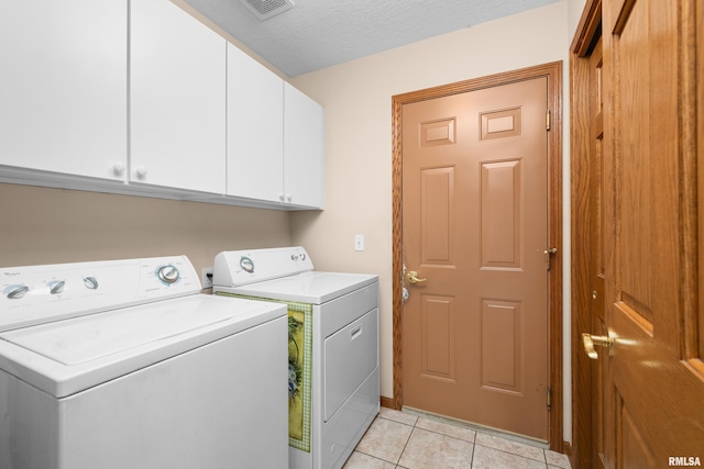 10 Briarwood Ln Unit 10, Rock Island, IL 61201 - washroom featuring cabinet space, washing machine and dryer, and light tile patterned floors