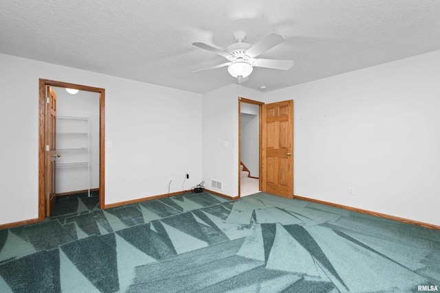 10 Briarwood Ln Unit 10, Rock Island, IL 61201 - carpeted empty room with a ceiling fan, stairs, and a textured ceiling