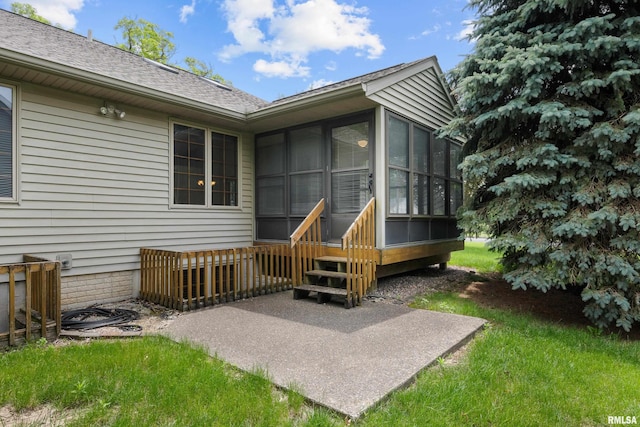 10 Briarwood Ln Unit 10, Rock Island, IL 61201 - back of property featuring a sunroom, a patio area, and roof with shingles