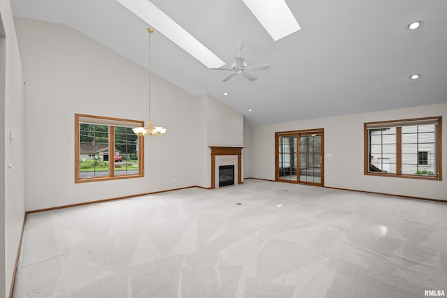 10 Briarwood Ln Unit 10, Rock Island, IL 61201 - unfurnished living room featuring high vaulted ceiling, a skylight, light colored carpet, recessed lighting, and a glass covered fireplace