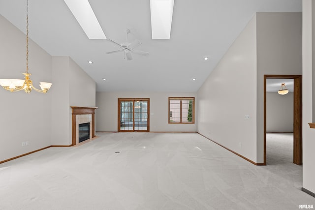 10 Briarwood Ln Unit 10, Rock Island, IL 61201 - unfurnished living room featuring a skylight, light colored carpet, high vaulted ceiling, a tiled fireplace, and a chandelier