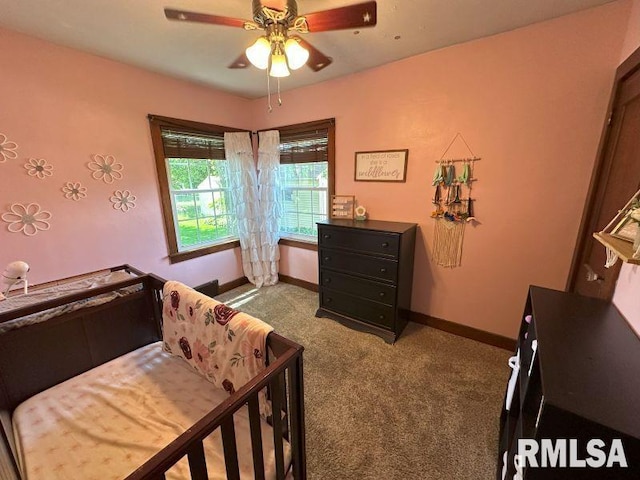 611 13th St, De Witt, IA 52742 - bedroom with carpet floors and a ceiling fan