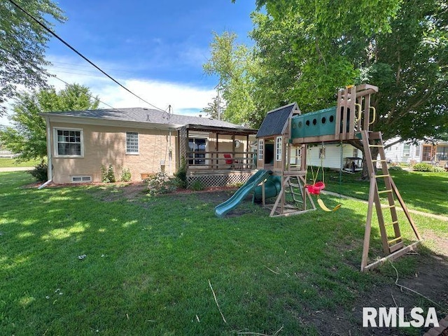 611 13th St, De Witt, IA 52742 - rear view of house featuring a playground and a yard